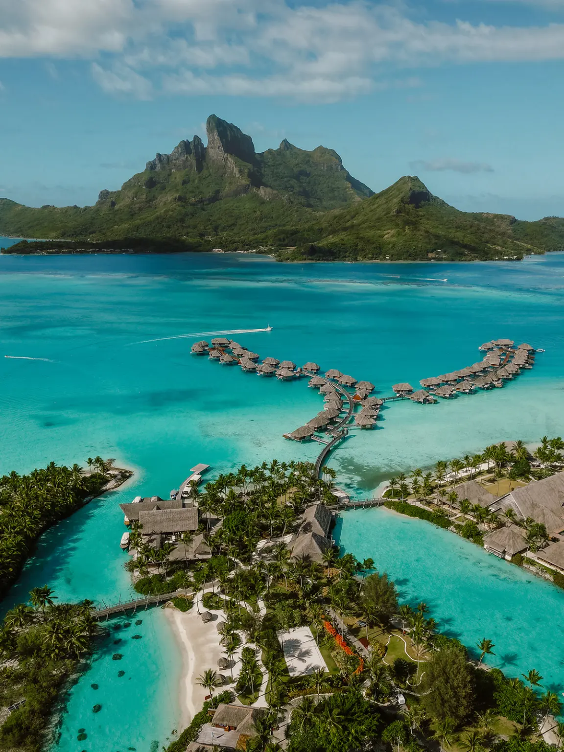 Overwater bungalows reaching into the Bora Bora lagoon.