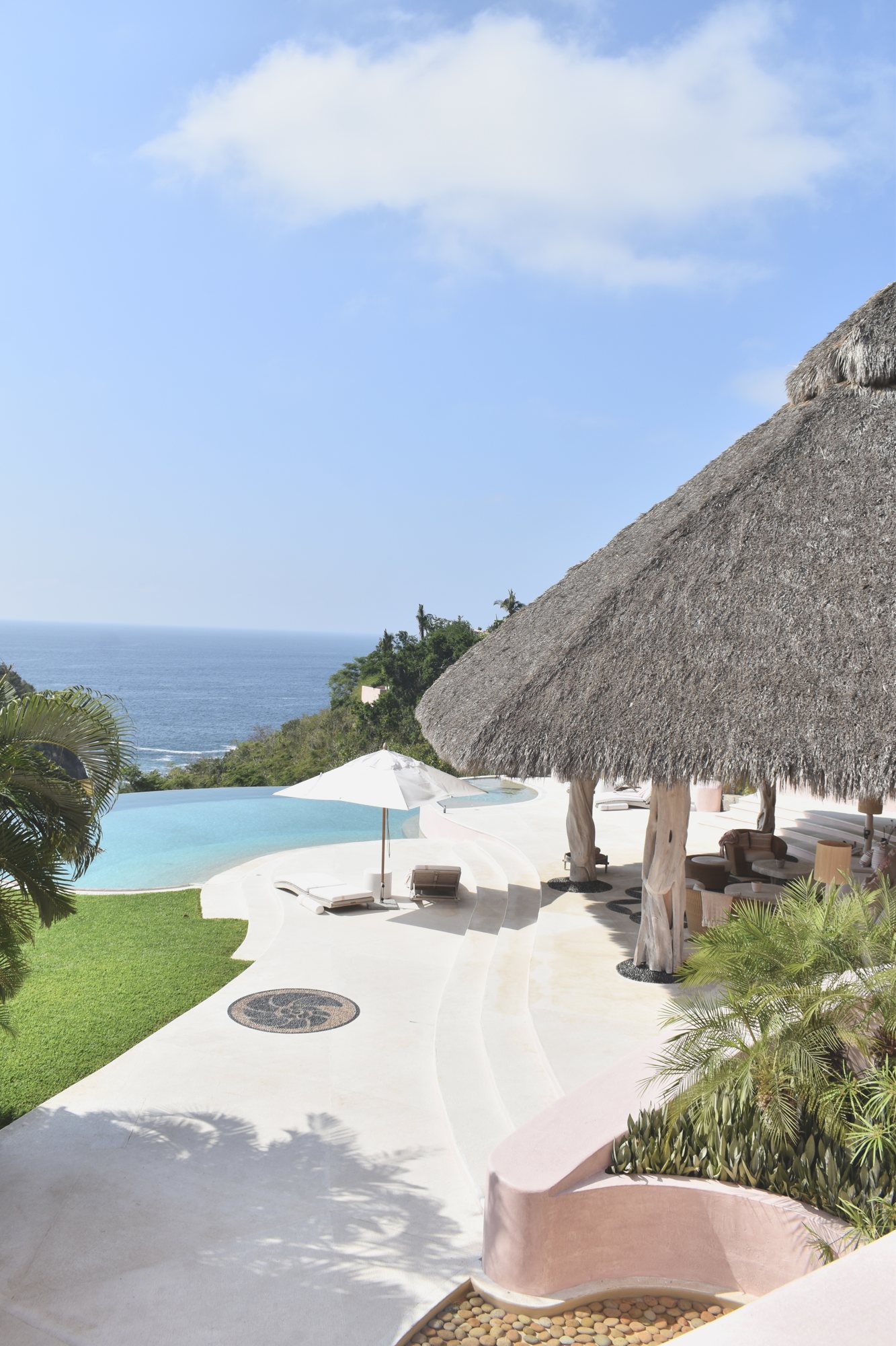 A thatched pool villa in the evening light.