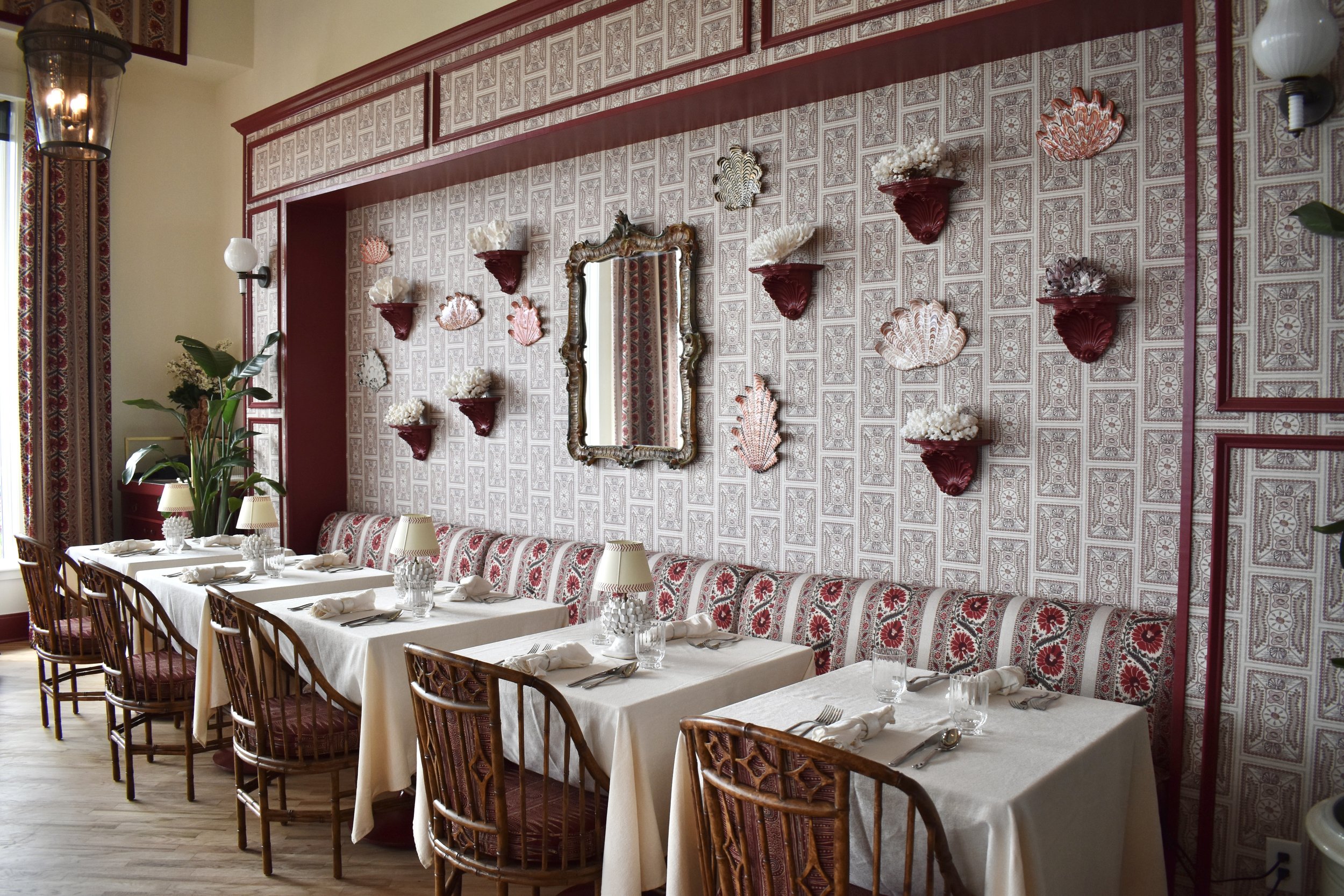 A dining room with a long, beautifully set table.