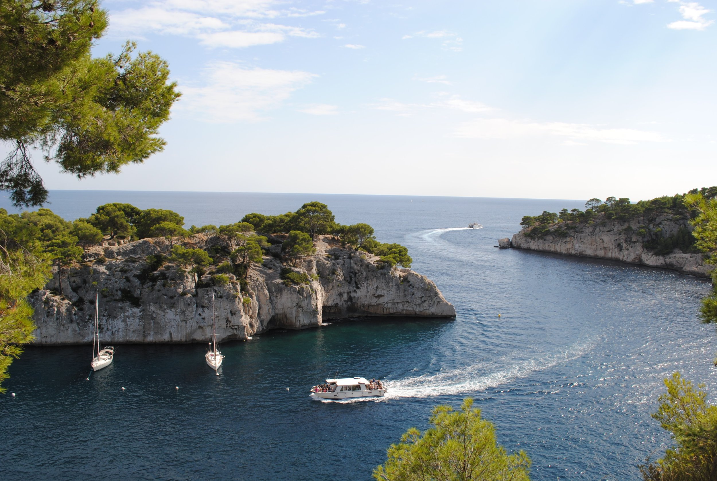 Wooden boats moored in a quiet Corsican bay.