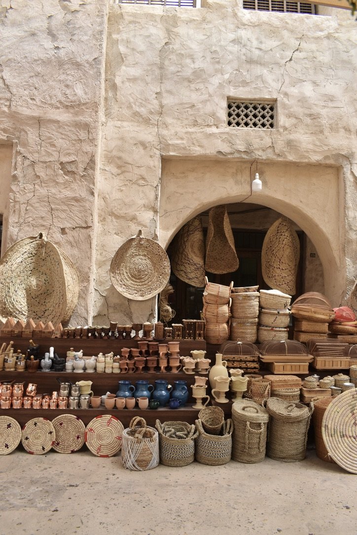 A display of woven baskets, pottery, and artisan wares.