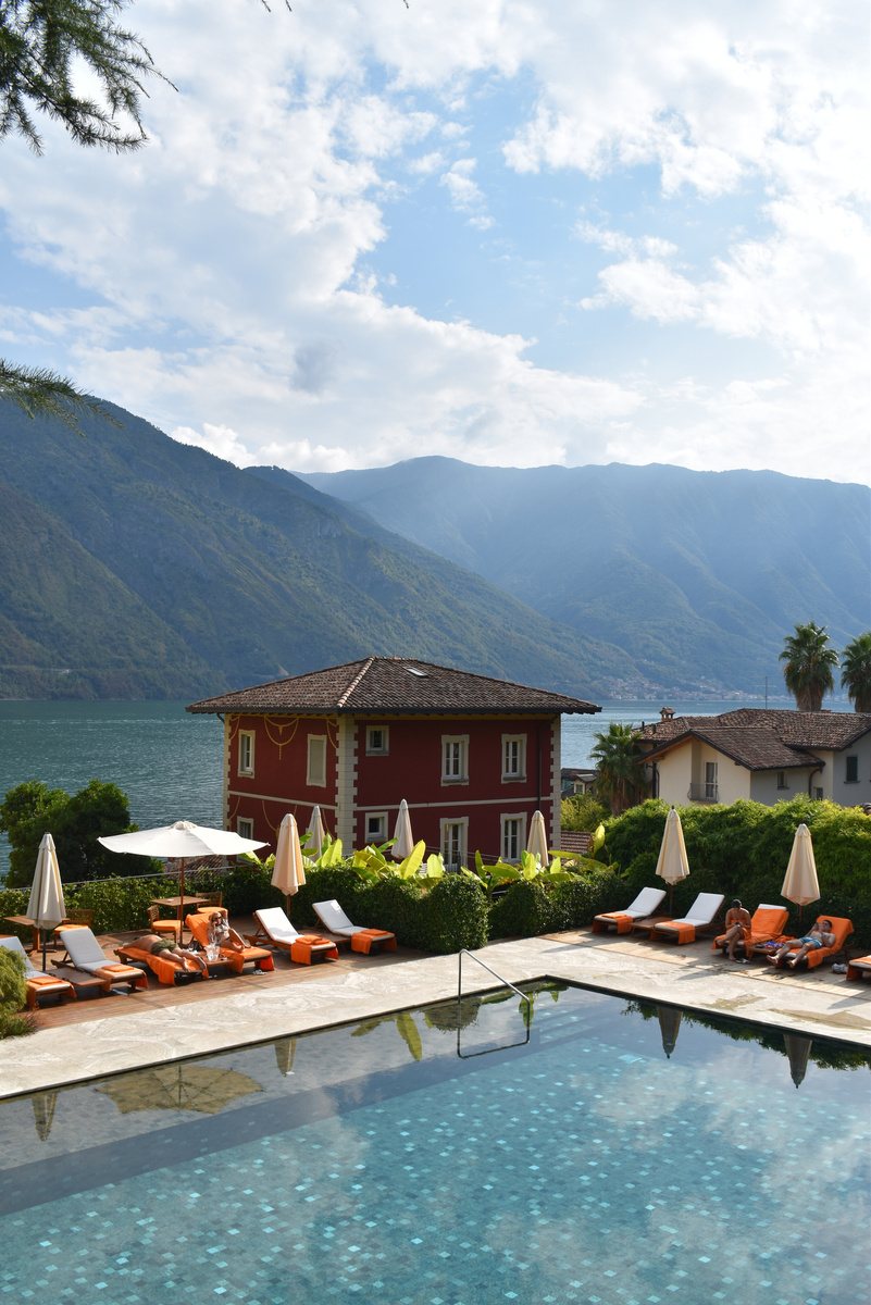 Loungers beside a pool at a terracotta villa above the sea.