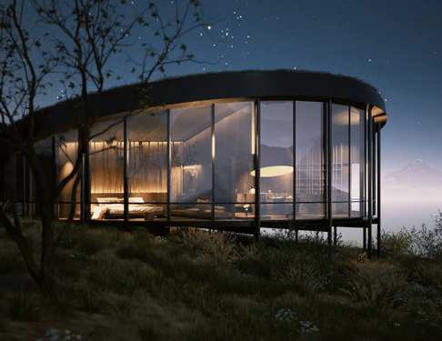 A glass-walled villa glowing at night under the stars.