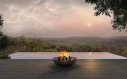 A firebowl on a deck at dusk at Karingani.