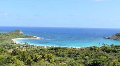 A turquoise bay wrapping a white-sand beach in Antigua.