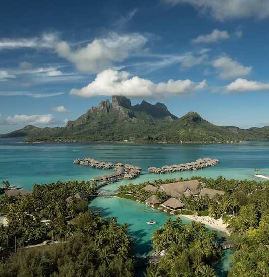 Overwater bungalows reaching into the Bora Bora lagoon.