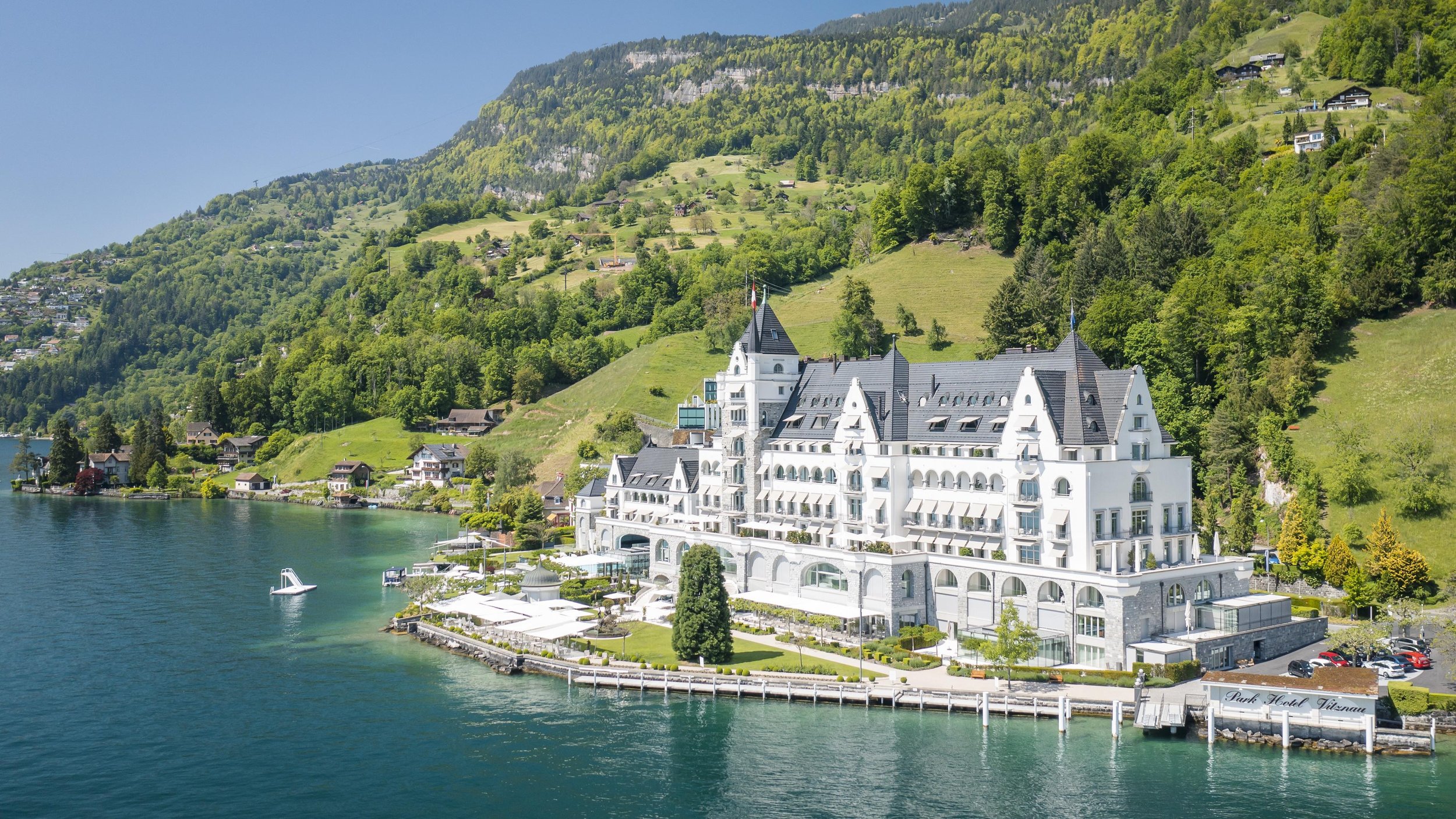 A grand white hotel on a Swiss lakeshore.
