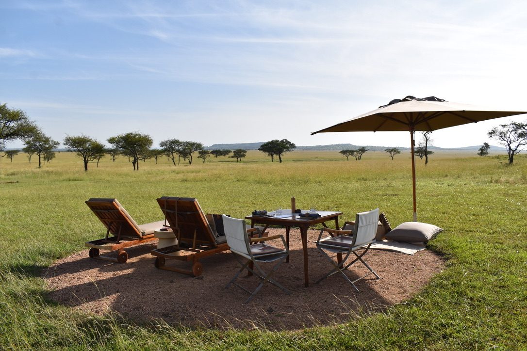 A bush dining setup at dusk.